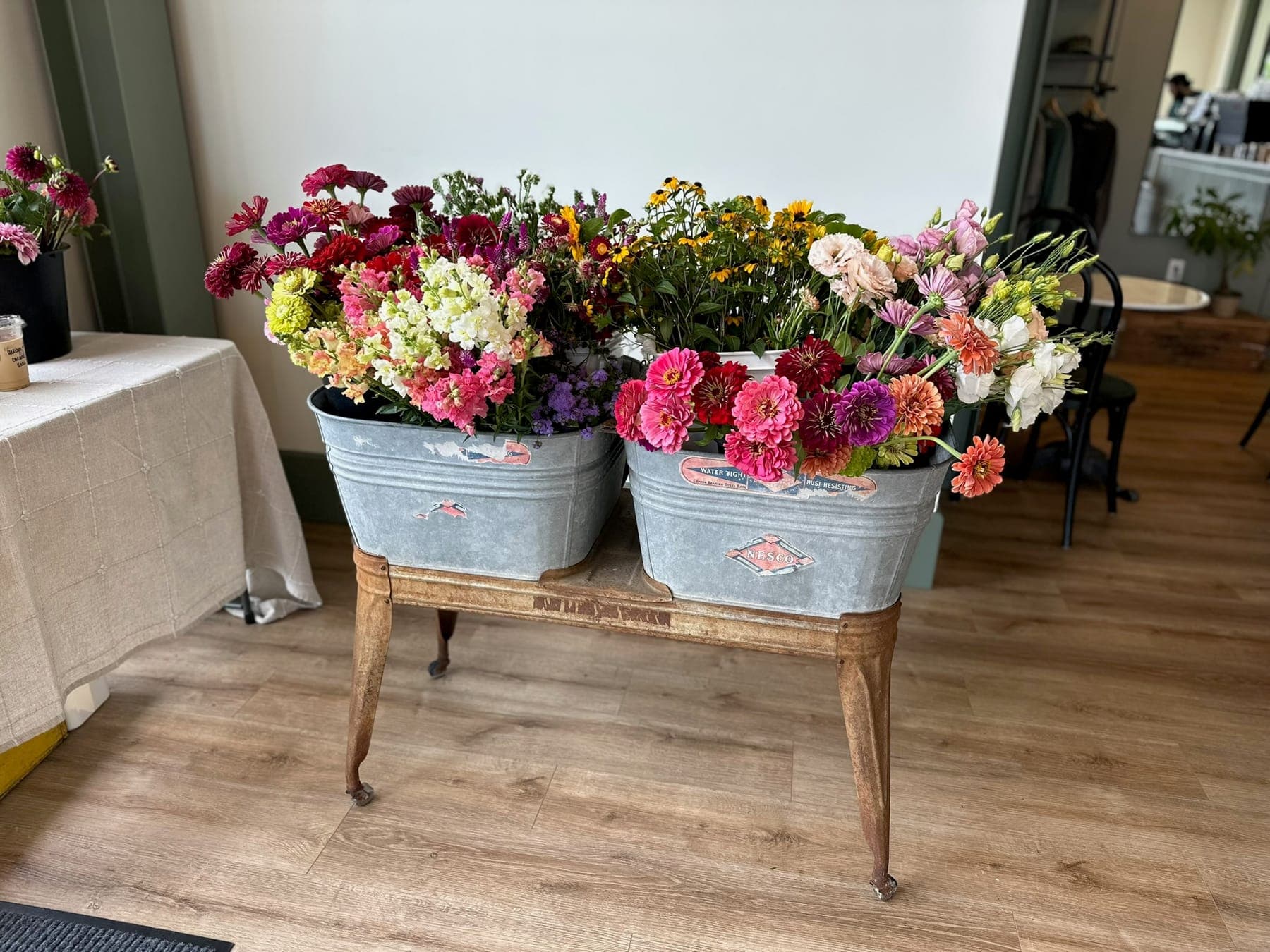 Galvanized buckets brimming with fresh-cut bouquets ready for market